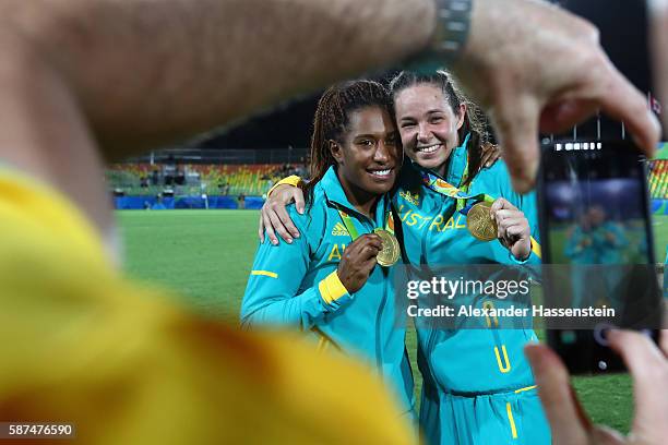 Gold medalist Ellia Green of Australia and her team mate Chloe Dalton pose with her Gold medal after the medal ceremony for the Women's Rugby Sevens...