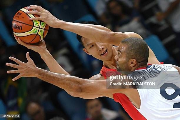 China's forward Yi Jianlian vies with France's point guard Tony Parker during a Men's round Group A basketball match between France and China at the...