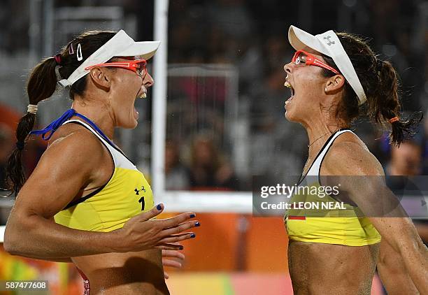 Spain's Liliana Fernandez Steiner and Elsa Baquerizo McMillan celebrate after winning the women's beach volleyball qualifying match between Spain and...