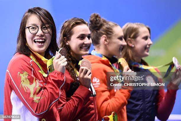 Hungary's Katinka Hosszu celebrates with silver medallist USA's Kathleen Baker and equal bronze medallists Canada's Kylie Masse and Chinese's Fu...