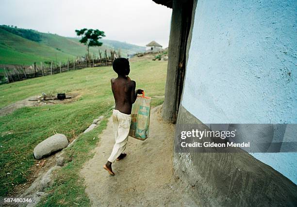 Two months after starting his antiretroviral treatment for AIDS, orphan Zamokuhle Mdingwe fetches the bag which holds his antiretroviral medication....