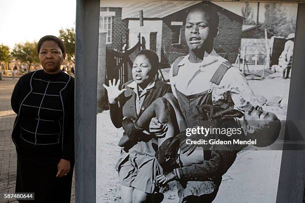 Antoinette Sithole, sister of Hector Peterson who was murdered by South African police thirty years ago, poses alongside the iconic image by Sam...