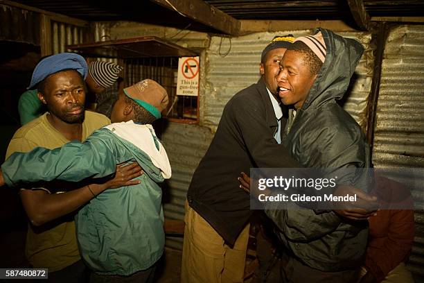 Residents of Elias Motsauledi informal settlement dance and enjoy a drunken evening at Makarina's shebeen, which is a small squatter shack. In the...