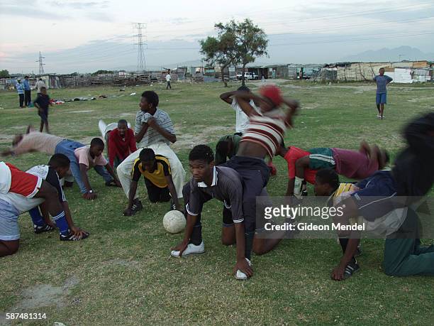 Members of an amateur football team do strength training as part of their coaching session in Khayelitsha, the vast shack settlement of nearly two...