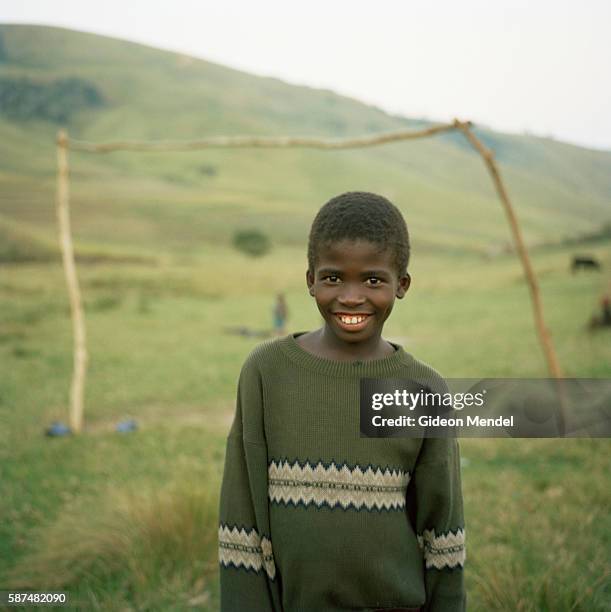 Positive orphan Zamokuhle Mdingwe poses on the soccer pitch on a hillside outside his village of Xurana. It is more than three years since Zamo began...