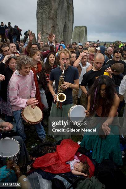 Baby sleeps peacefully as an eclectic mix of partygoers, revellers, pagans, druids and drummers make music and dance within the stone circle of...