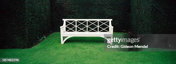 View of a bench set within neat hedges at Sandringham House, the much-loved country retreat of Her Majesty the Queen. It has been the private home of...