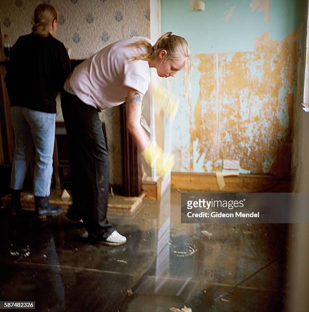 Carrie-Ann Garner tries to sweep the last of the floodwater out Teresa Woodward's house in Toll Bar village. Carrie Ann is a neighbour who was...
