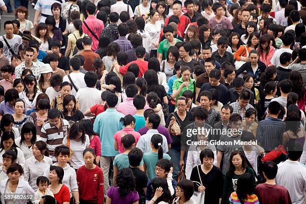 Solid mass of pedestrians cross a busy intersection in the Xidan shopping area, during the Mayday holiday break. Shopping is one of the most popular...