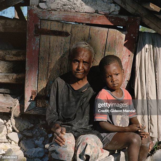 Erlande Toussaint, aged 63, with her grandchild Junior Delva outside her home in Kayobry near Beinet which was totally destroyed by Hurricane Gustav....