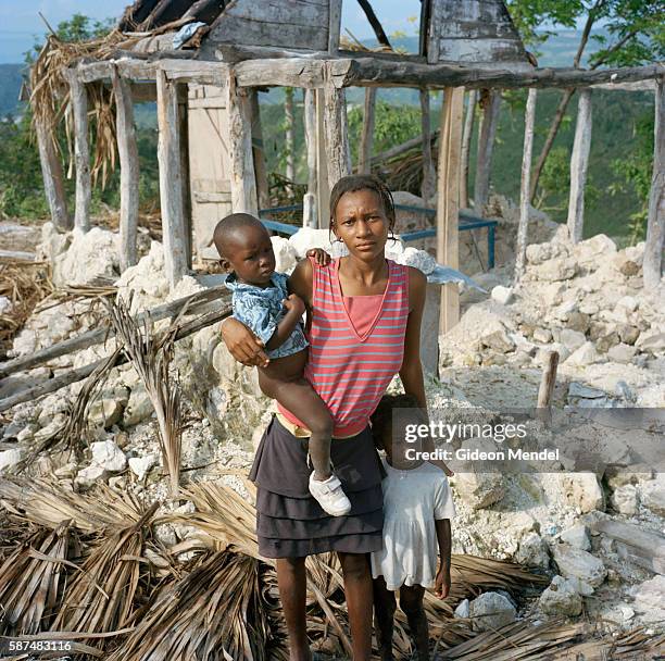 Rosline Pierre Louis, aged 22, with her children Madienry Piere Louis, , and Galy Pierre Louis,, outside her home in Kayobry near Beinet which was...