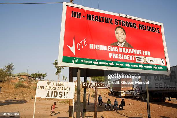 Sign warning people to guard against AIDS is situated close to the border post in Chirundu. The large billboard above the sign is advocating one of...