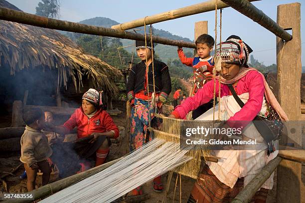 Mi-lung uses a traditional loom to weave the cotton cloth the Akha value highly within their culture. This is a community activity around which women...