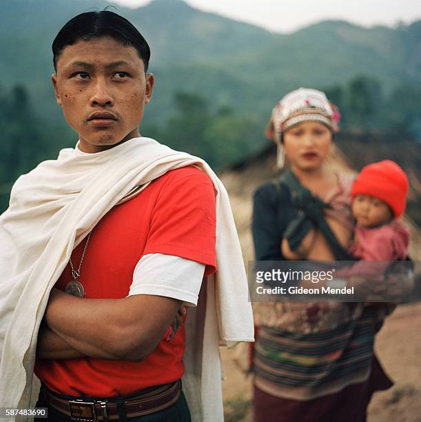Young Akha couple with their child in the Ban Nam Lai Akha village. The Akha are a hill tribe of subsistence farmers known for their artistry. This...