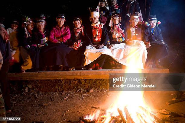 Akha teenagers sing traditional songs as they participate in the traditional evening entertainment for teenagers in the Akha village of Ban Nam Lai....