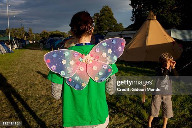 Persson with angel wings walks through the family section of the campsite at the Green Man Festival. This is an independent music festival held...