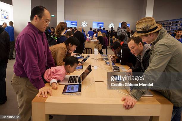 Enthusiastic customera try out Apple computer products at the Apple Store in new Westfield Stratford City mall which has seen huge crowds of...