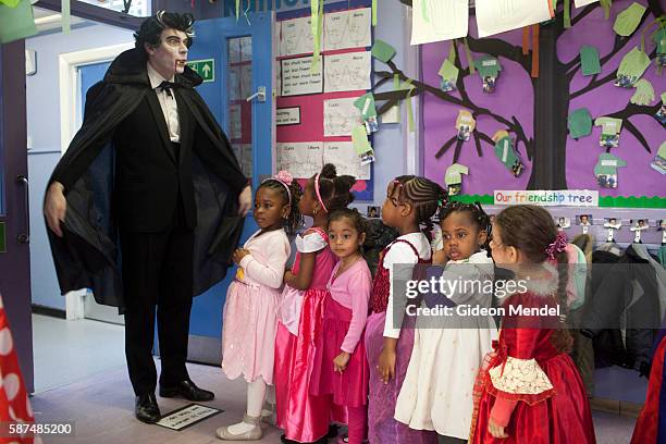 Teacher dressed as Dracula has his nursery class line up to at Kingsmead Primary School in Hackney on World Book Day, when staff and pupils had been...