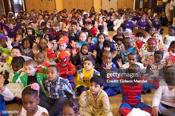 Children at Kingsmead Primary School in Hackney enjoy their morning assembly on World Book Day. They had all been asked to come to school dressed as...