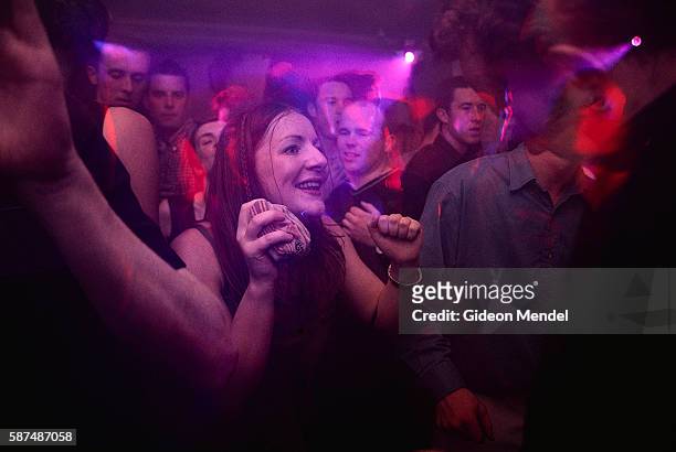 Woman dances on the packed dance floor at the Kitchen, a night club in Dublin's Temple Bar neighborhood which is owned by rock band U2.