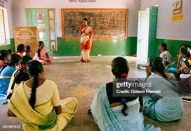 Volunteer health guide demonstrates to her peers the correct way to use a condom during an educational workshop at Seva Nilayam. Seva Nilayam is a...