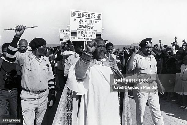 Priest leads a funeral procession for four United Democratic Front activists from Queenstown who were abducted and murdered by the South African...