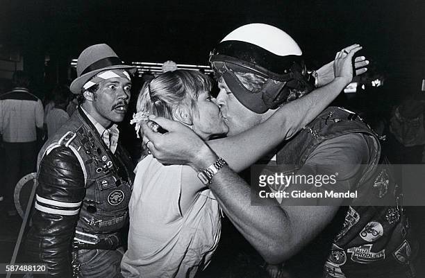 Members of the Johannesburg Hell's Angels kiss while another Hell's Angel member looks on with apparent alarm in Hillbrow, South Africa.