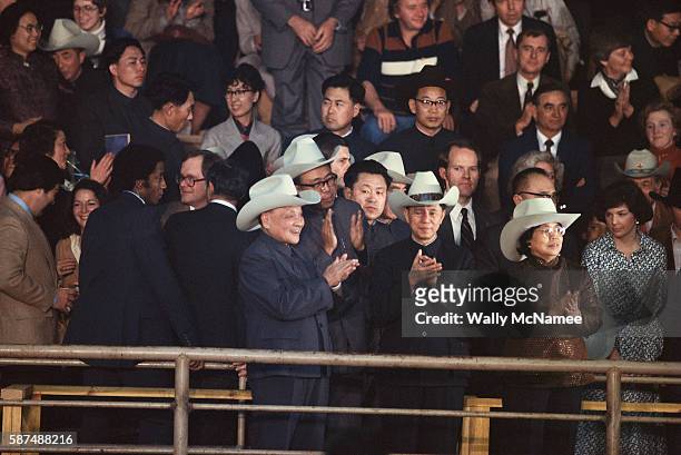 Peoples Republic of China leader Deng Xiaoping, wearing a cowboy hat, applauds at a Houston rodeo during a U.S. State visit, 1979.