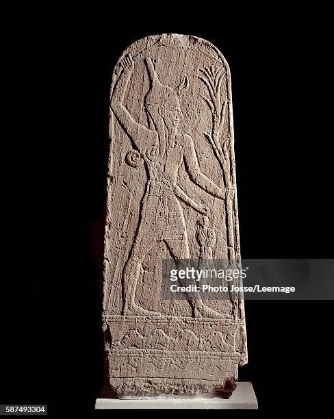 Sandstone stele of god Baal holding thunderbolt from Ugarit - Sculpture of the 15th century BC, Syria. Louvre museum, Paris