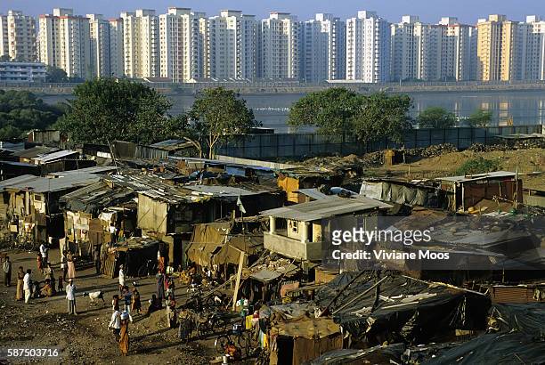 Poverty and wealth visible in one frame with a poor slum area known as Cuff Parade in the foreground and a string of white hi-rise apartments for the...