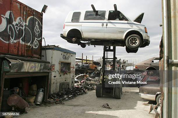 Forklift holds a wrecked Chevrolet Astro minivan aloft in a junkyard in the Iron Triangle, a 13-block area in Flushing, Queens, and the largest...