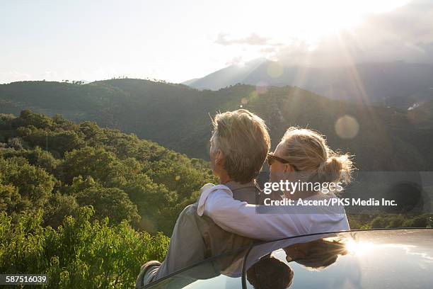 couple relax by car,look out across hills - blonde hair back stock pictures, royalty-free photos & images