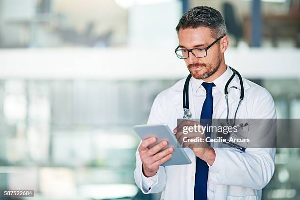 my tablet allows me to better diagnose and treat patients - stethoscope pills stock pictures, royalty-free photos & images