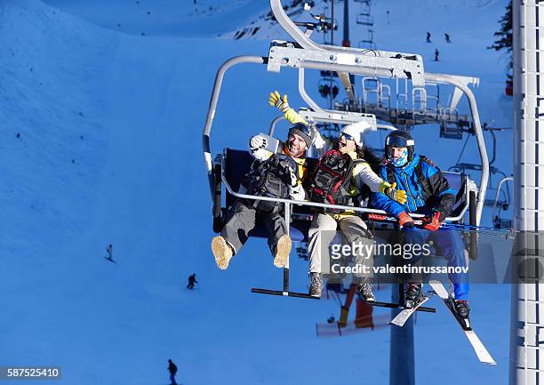 cheerful young people making selfie on ski lift - woman on ski lift stock pictures, royalty-free photos & images