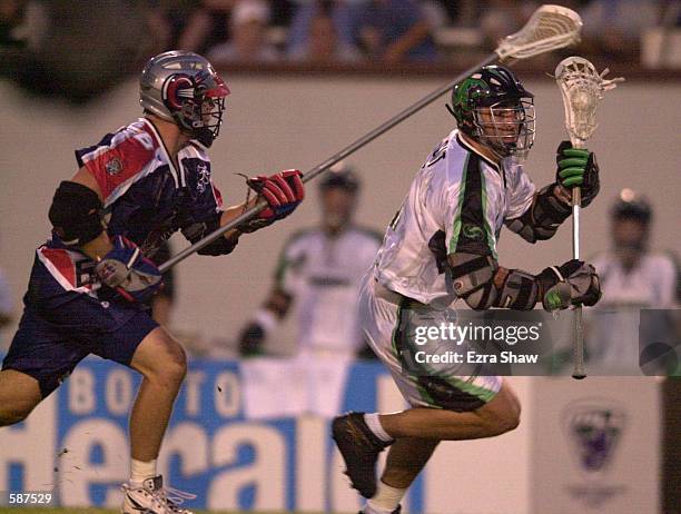 Gary Gait of the Long Island Lizards fights for the ball with Ryan Curtis of the Boston Cannons during their game at Cawley Stadium in Hudson,...
