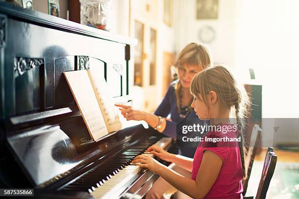 little girl practicing piano - piano bildbanksfoton och bilder