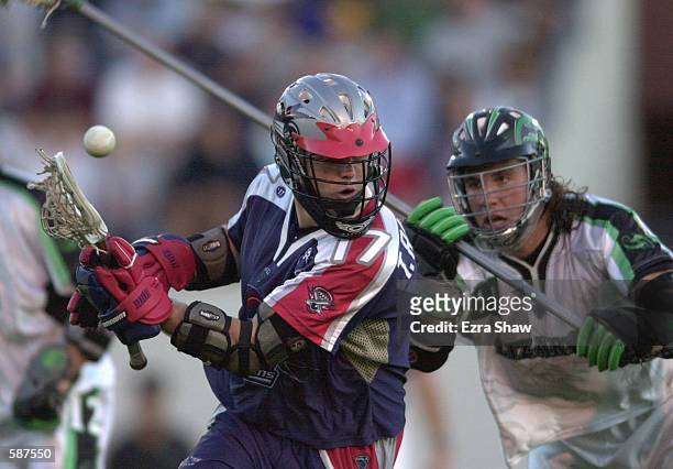 Brian Spallina of the Long Island Lizards fights for the ball with Tucker Radebaugh of the Boston Cannons during their game at Cawley Stadium in...