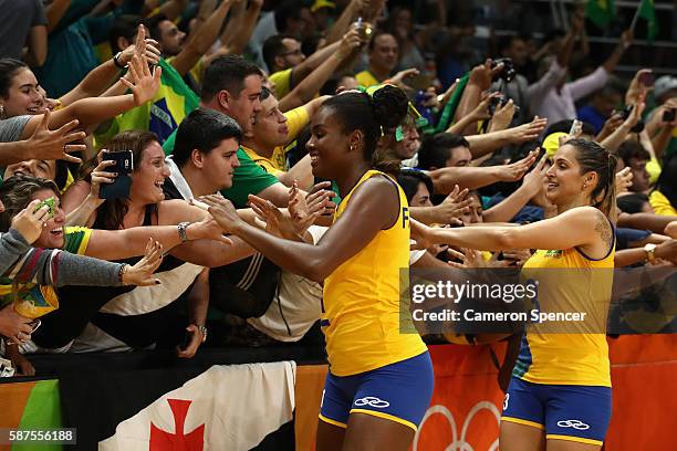 Fabiana Claudino of Brazil and Danielle Lins of Brazil thank fans after winning the Women's Preliminary Pool A match between Argentina and Brazil on...