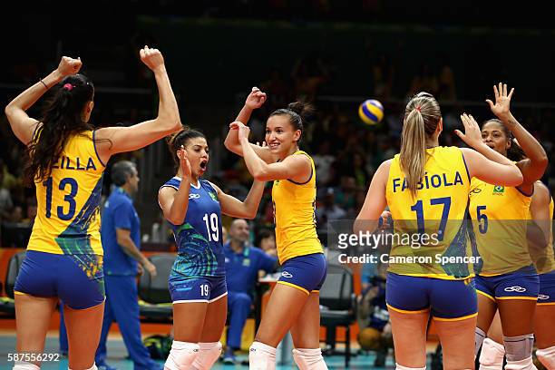Gabriela Braga Guimaraes of Brazil and team mates celebrate winning the Women's Preliminary Pool A match between Argentina and Brazil on Day 3 of the...