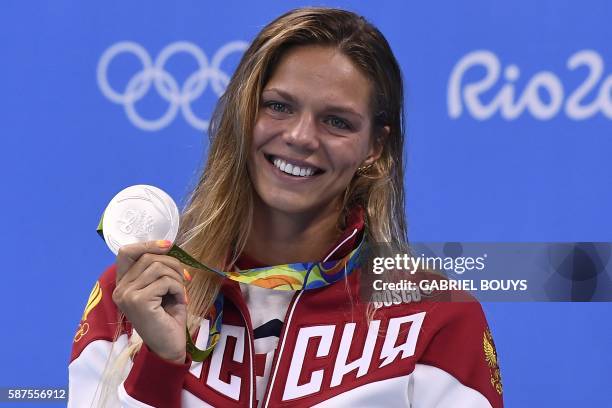 Russia's Yulia Efimova poses with her silver medal on the podium of the Women's 100m Breaststroke during the swimming event at the Rio 2016 Olympic...