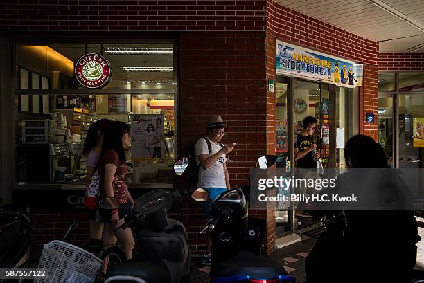 People play Pokemon Go on their smartphones on August 8, 2016 in Taipei, Taiwan. 'Pokemon Go,' which has been a smash-hit across the globe was...