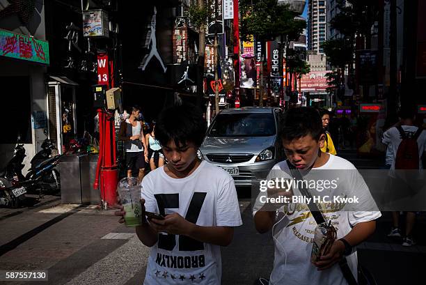 People play Pokemon Go on their smartphones on August 8, 2016 in Taipei, Taiwan. 'Pokemon Go,' which has been a smash-hit across the globe was...