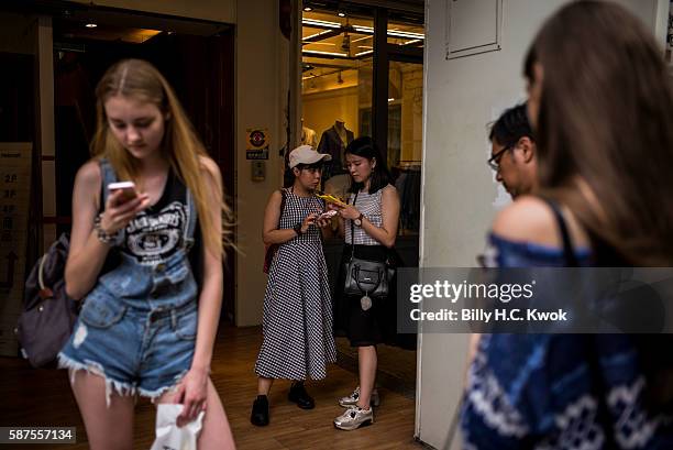 People play Pokemon Go on their smartphones on August 8, 2016 in Taipei, Taiwan. 'Pokemon Go,' which has been a smash-hit across the globe was...