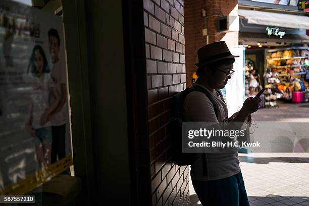 Man plays Pokemon Go on his smartphone on August 8, 2016 in Taipei, Taiwan. 'Pokemon Go,' which has been a smash-hit across the globe was launched in...