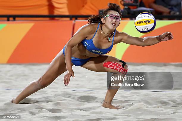 Yuan Yue of China dives for the ball during the Women's Beach Volleyball preliminary round Pool C match against Kerri Walsh Jennings and April Ross...