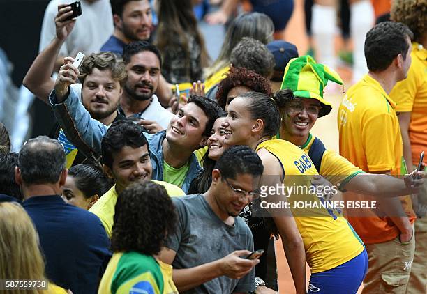 Brazil's Gabriela Braga Guimaraes poses for a picture with supporters after winning the women's qualifying volleyball match between Brazil and...