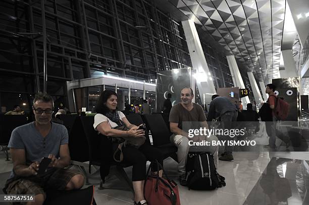 Passengers wait to board their flights at the newly opened terminal 3 at Soekarno-Hatta International Airport in Tangerang, on the outskirts of...