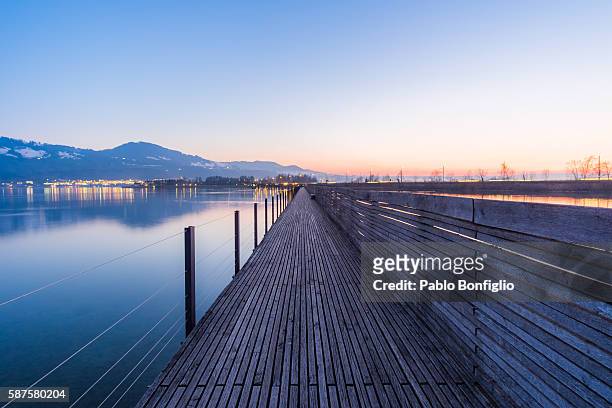 seedamm pier after sunset - lake zurich stock pictures, royalty-free photos & images