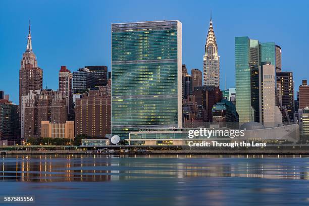 united nations headquarters across east river during dawn - headquarters stock pictures, royalty-free photos & images