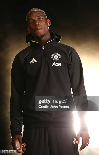 Paul Pogba of Manchester United poses after signing for the club at Aon Training Complex on August 8, 2016 in Manchester, England.
